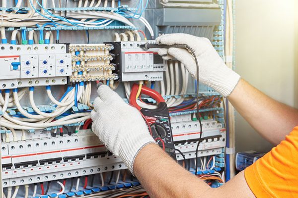 A closeup of an electrical engineer working in a power electrica